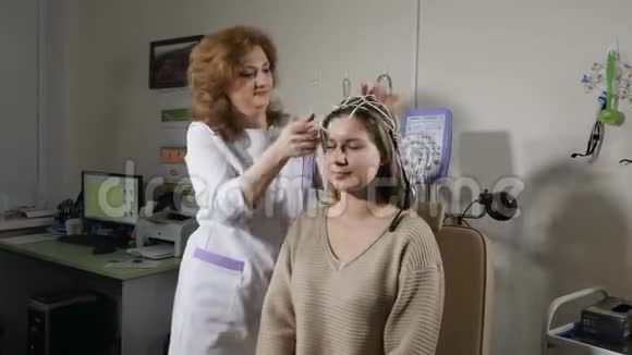 癫痫自闭症头部损伤的处理女护士帮助病人准备脑电图测试医院里的医生视频的预览图