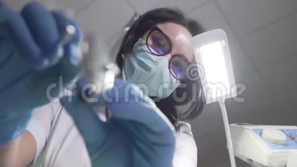 具有操纵仪器的女性高加索口腔医生的特写式底视图牙科口腔科视频的预览图