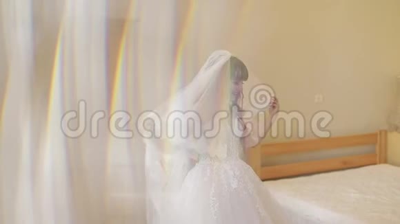 漂亮可爱的新娘穿着婚纱靠近窗户漂亮女人视频的预览图