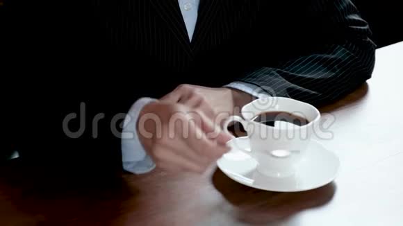 女商人用勺子搅拌咖啡杯的手视频的预览图