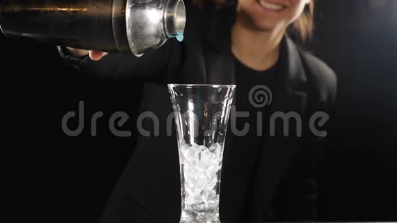 酒保准备亮蓝色鸡尾酒用冰做酒精鸡尾酒女酒精灌制液体视频的预览图