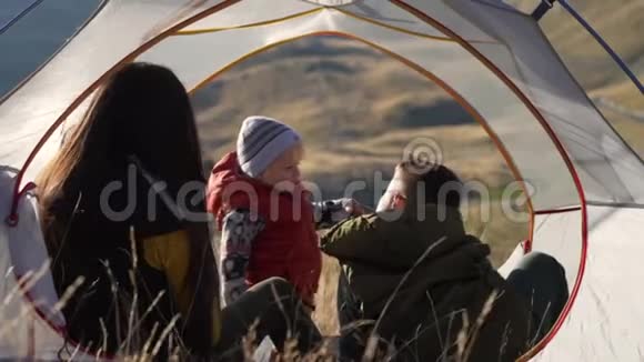 快乐旅行者单身妈妈和孩子在旅行帐篷里玩耍特写视频的预览图