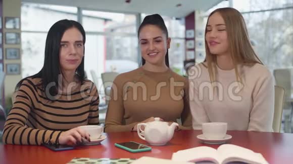 三个年轻自信的女人看着镜头微笑的肖像最好的朋友在晴天的咖啡馆里休息视频的预览图