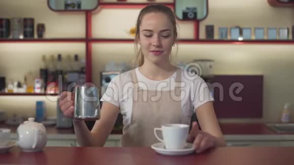 在咖啡馆里准备卡布奇诺的专业女咖啡师的肖像年轻漂亮的白种人妇女视频的预览图