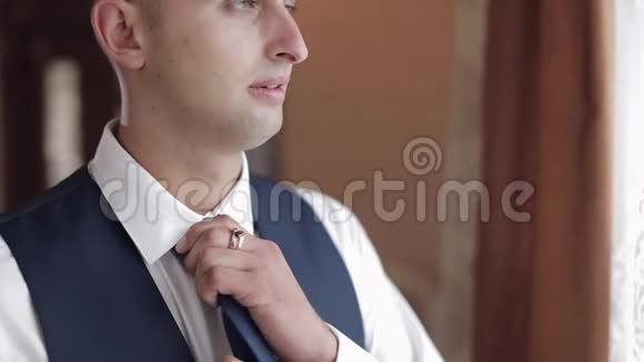 新郎把领带系在脖子上准备去找新娘婚礼日视频的预览图