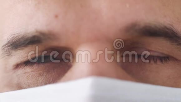 疲惫的医生戴着医学面具的眼睛视频的预览图