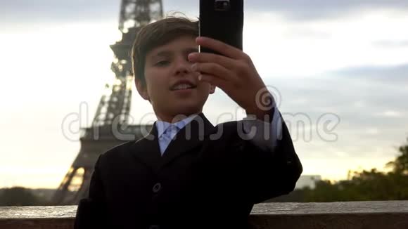 男孩在埃菲尔铁塔的背景上自拍视频的预览图