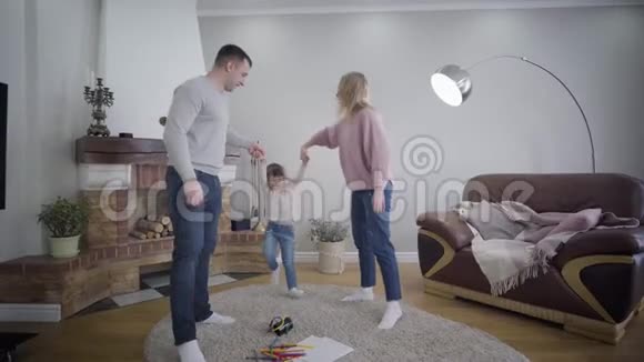 年轻的高加索夫妇牵着女儿手抚养孩子玩积极的家庭享受时光视频的预览图