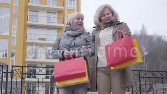 高加索族妇女购物后漫步在城市街头快乐在职中年退休人士享受闲暇时光视频的预览图