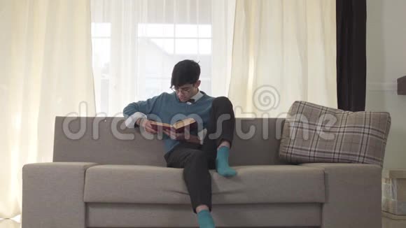 一个戴眼镜的白人男人看着讨厌的室友来了坐在沙发两边视频的预览图
