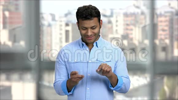 年轻的印度男子使用空白透明平板电脑视频的预览图