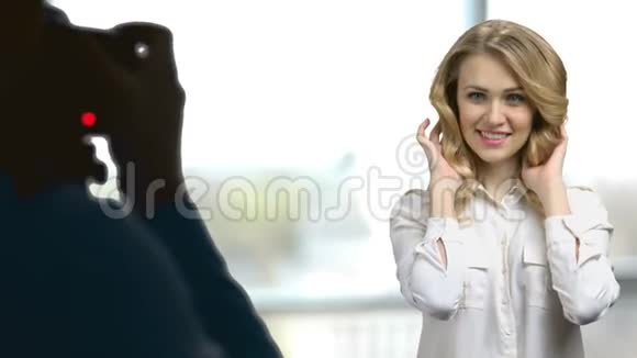 年轻性感的金发女人为接线员的相机摆姿势视频的预览图