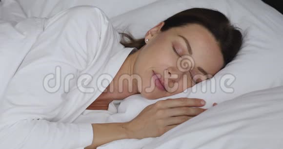 快乐漂亮的女士睡在床上早上做白日梦视频的预览图