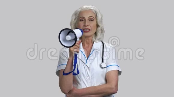 老年女医生用扩音器讲话的肖像视频的预览图