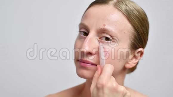 女人正在用玉石按摩脸按摩瓜沙视频的预览图
