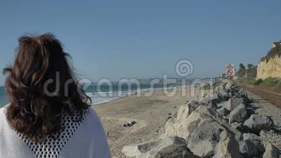 加州圣克莱门特的夏日海滩上的一位老妇人在看着美丽的风景的海洋视频的预览图