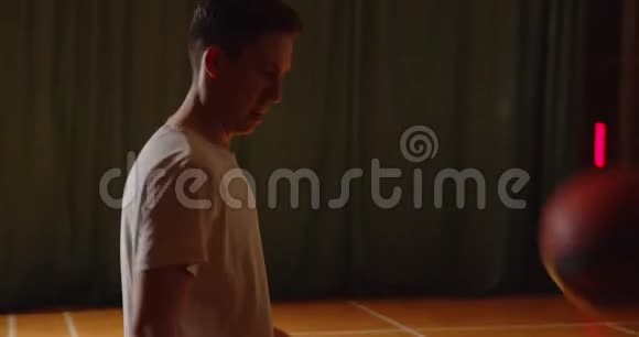 两名年轻的篮球运动员进行篮球比赛业余选手在大厅进行体育拼花剪影并向对方运球视频的预览图