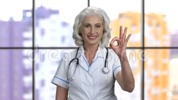 年长的女医生戴着听诊器表现得很好视频的预览图