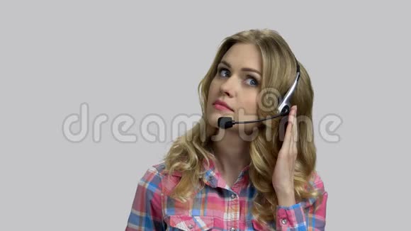 年轻女接线员带耳机帮助客户热线视频的预览图
