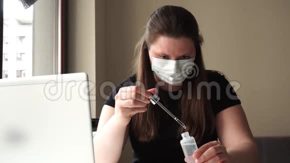 戴着医用口罩的黑发白种人女孩在电脑前的检疫工作时手里拿着试管视频的预览图