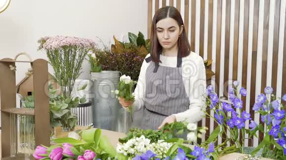 年轻女子花店检查和选择最好的花束在车间或花店视频的预览图