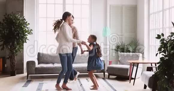 3个三岁的妇女家庭在客厅跳舞视频的预览图
