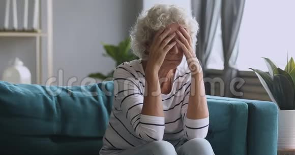 沮丧的成熟女人在家中患有严重的头痛视频的预览图
