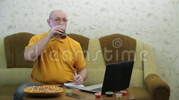 一个拿着笔记本电脑的人正在吃披萨晚餐前完成工作视频的预览图