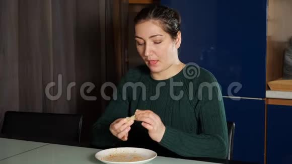 饥饿的女人吃午饭舔盘子里剩下的食物视频的预览图