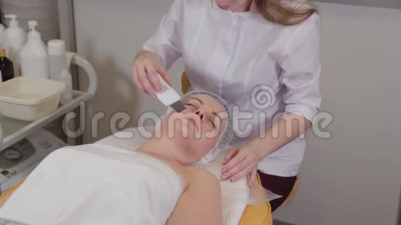 专业美容师女性对病人做超声波洗脸视频的预览图