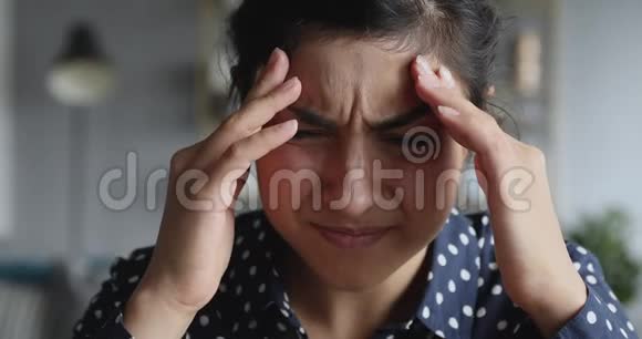 沮丧的压力年轻的印度妇女应对头痛偏头痛特写视频的预览图