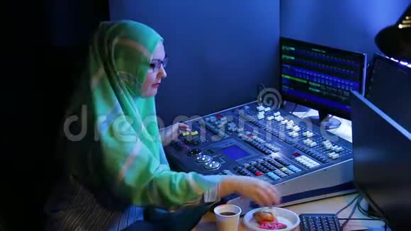 戴着头巾和眼镜的穆斯林妇女一个照明设计师设计灯光喝咖啡吃快餐视频的预览图