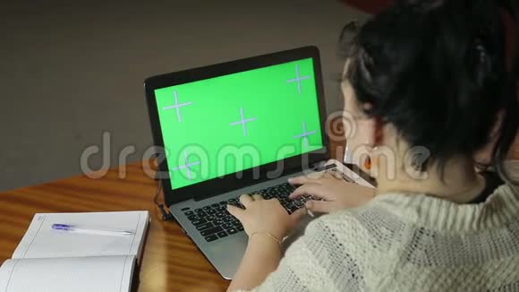一个女人晚上在办公室里徘徊在电脑键盘上完成打字视频的预览图
