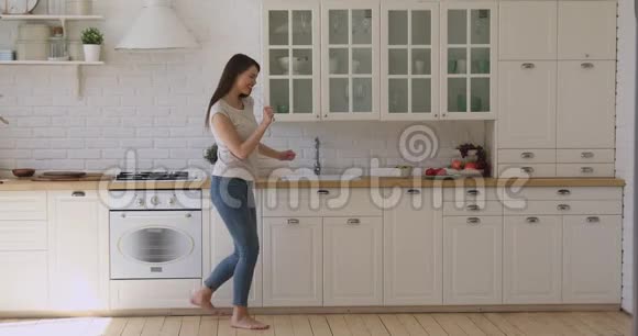 喜出望外的微笑女人在厨房准备早餐时玩得很开心视频的预览图