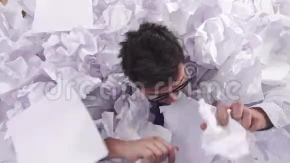 一个戴着眼镜戴着一大堆皱巴巴的纸的工作人员视频的预览图