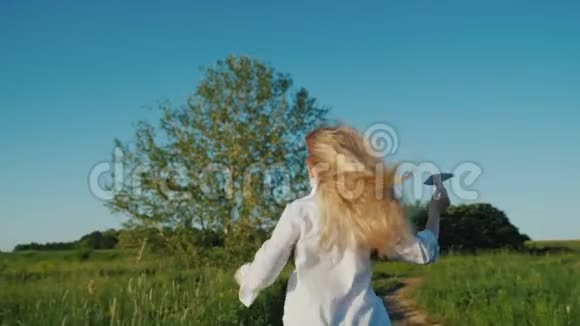 一个留着长发的女孩手里拿着纸飞机跑步婴儿梦概念视频的预览图