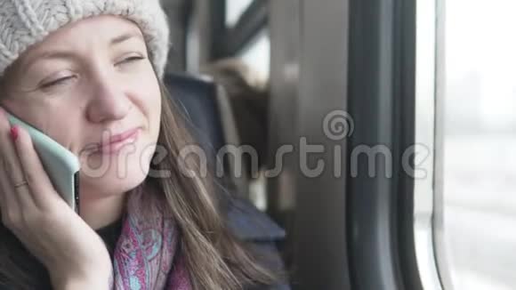 一位妇女在火车上用手机交谈视频的预览图