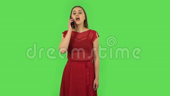 穿着红色衣服的温柔女孩在为移动而说话震惊然后高兴绿色屏幕视频的预览图