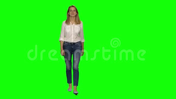 金发女人平静地走着在绿色的屏幕上微笑铬钥匙4k射击前景视频的预览图