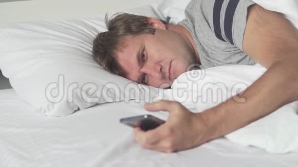 睡衣帅哥在床上用手机视频的预览图