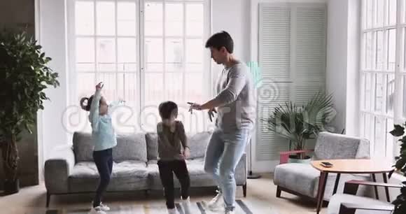 可爱的孩子模仿父亲在客厅跳舞的滑稽动作视频的预览图