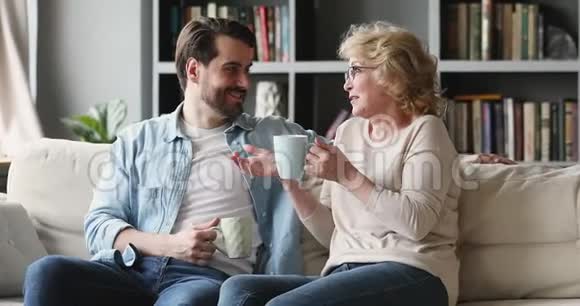 幸福的两代人一家人聊天喝茶坐沙发视频的预览图
