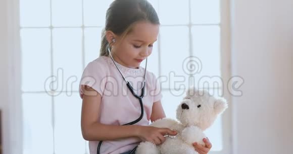 可爱的小女孩扮演医生治疗泰迪熊视频的预览图