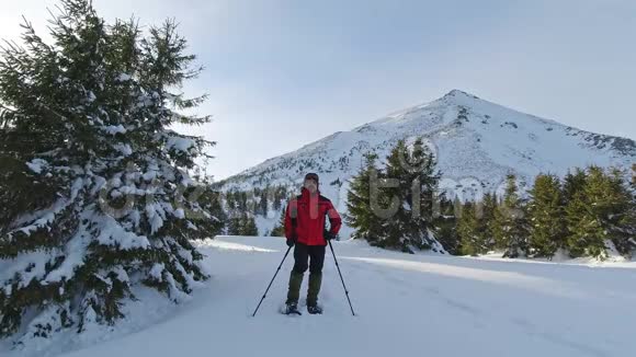 人在雪山的背景上摆姿势视频的预览图