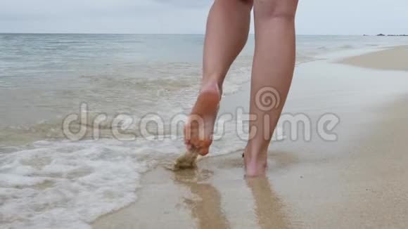 沙滩上的女性双腿溅起水波视频的预览图