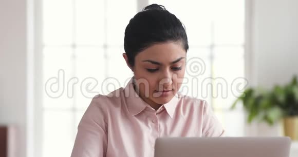 专注于印度商界女性使用笔记本电脑思考在办公室做研究视频的预览图