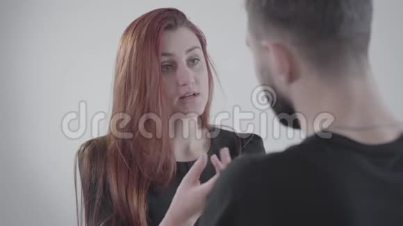 年轻愤怒的红发女人与无法辨认的丈夫或男朋友争吵的特写脸两个人吵架视频的预览图