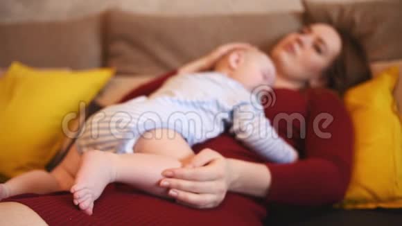 母亲睡觉时亲吻她的孩子妈妈照顾她儿子视频的预览图