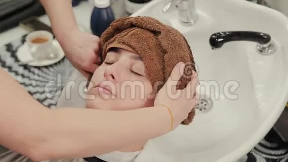 专业的理发师女士用毛巾给客户擦头发视频的预览图