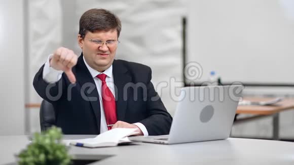 失望的男老板的肖像表情不愉快拇指朝下视频的预览图